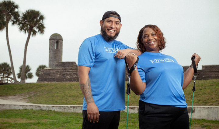 Wounded Warriors Jose Rodriguez and Yolanda Poullard smile while working out together outside.