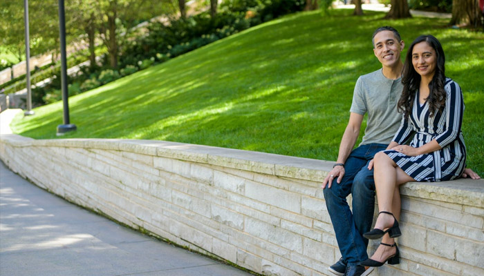 Sergio Alfaro and his wife Christina pose together on a ledge