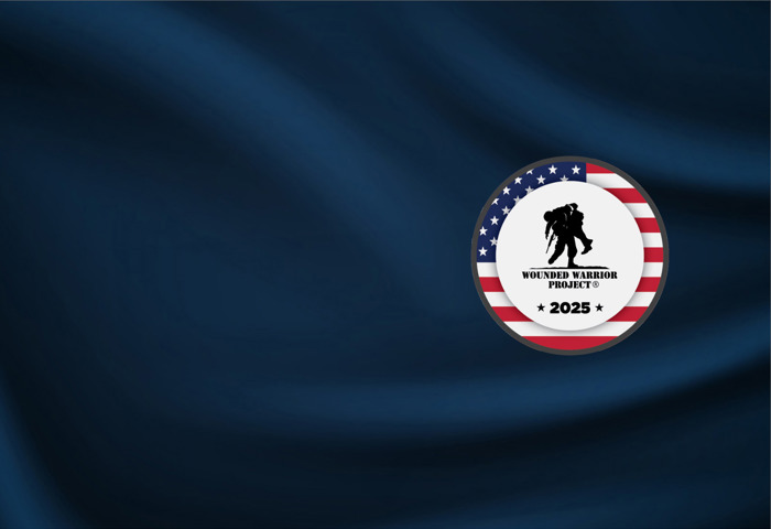 A silver challenge coin with WWP logo sits atop a navy display.