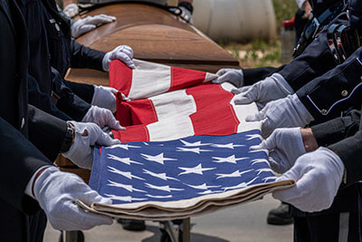 Service members folding the American flag.