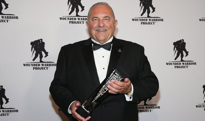 Tom Cocchiarella holding the Service Award at the 2018 Courage Awards and Benefit Dinner.