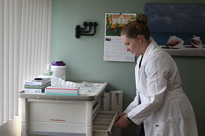 Lt. Col. Mariann Fark, chief of OB-GYN, Blanchfield Army Community Hospital, preps an exam room.
