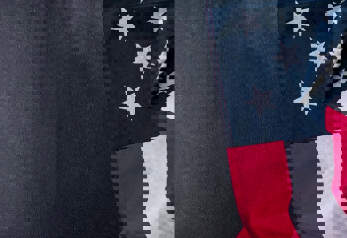 08/13-09/15_Draped American Flag With A Gray Textured Background