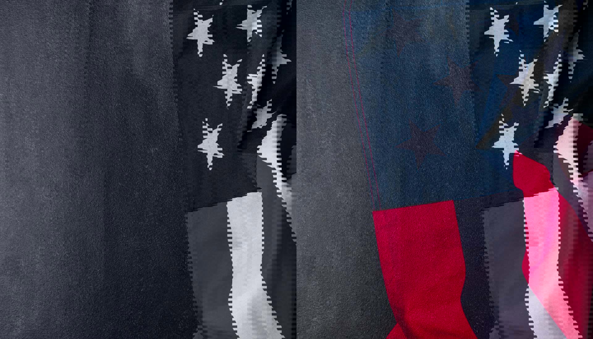 08/13-09/15_Draped American Flag With A Gray Textured Background