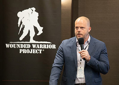 Bryan Tucker of CSX talks to attendees at WWP's Corporate Partners Summit. WWP has worked with CSX and other corporate partners to provide suicide prevention training and create safer veteran communities.