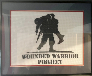 A framed image of the WWP logo that David cross-stitched