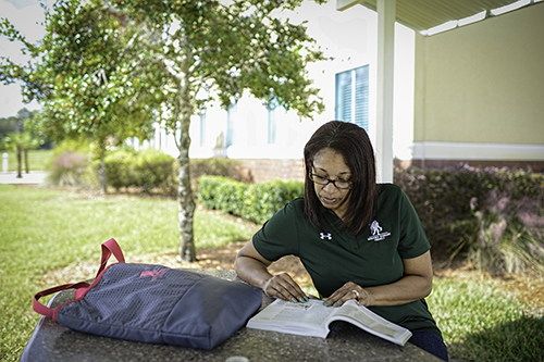 Women warrior studying on campus.