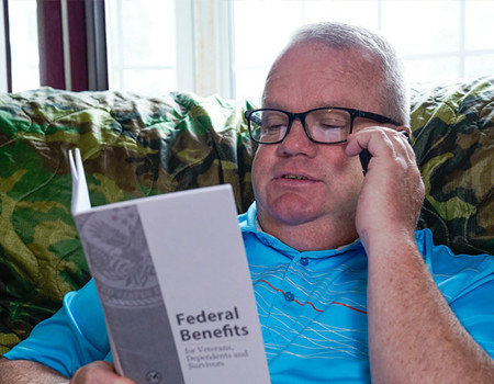 Wounded warrior Chris Hoff talking on the phone about his VA benefits.
