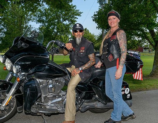 Wounded warrior Ray Andalio and his wife Deedra sitting on a motorcycle.