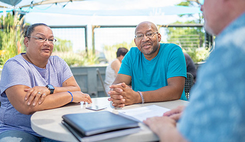 A warrior and his spouse go over finances with financial readiness counselor.