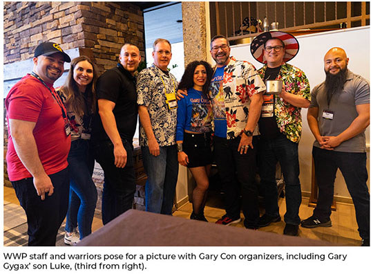 WWP staff and warriors pose for a picture with Gary Con organizers, including Gary Gygax’ son Luke Gygax.