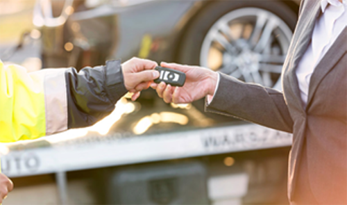Two hands passing a set of keys to each other