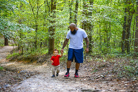 Marine Corps veteran Eric Delion goes for a walk with his young son.