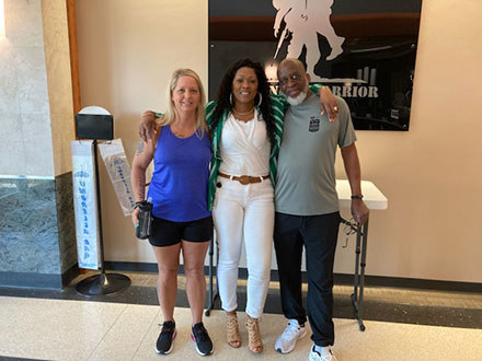 Chris and Peggy stand with Chris' family support member Courtney, whom Peggy was also able to connect with WWP programs and services.