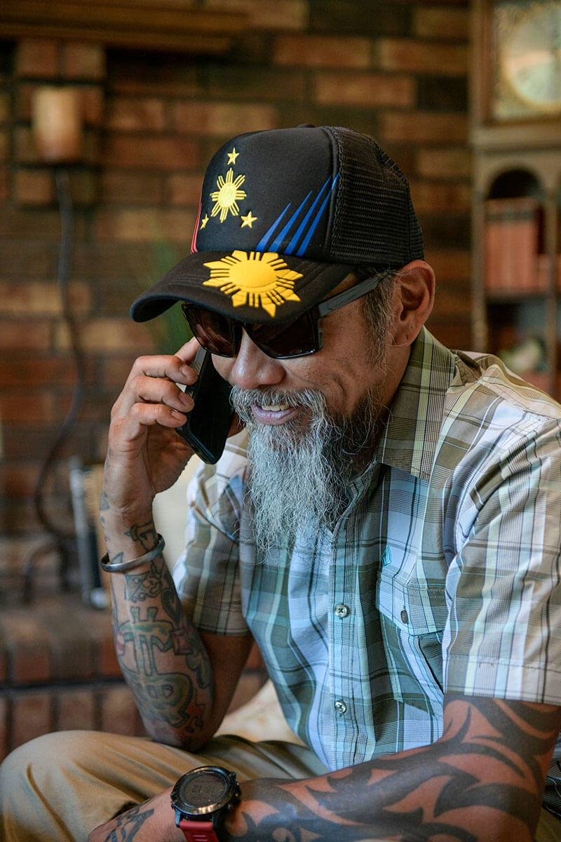 Wounded warrior Ray Andalio sitting at home on the phone.