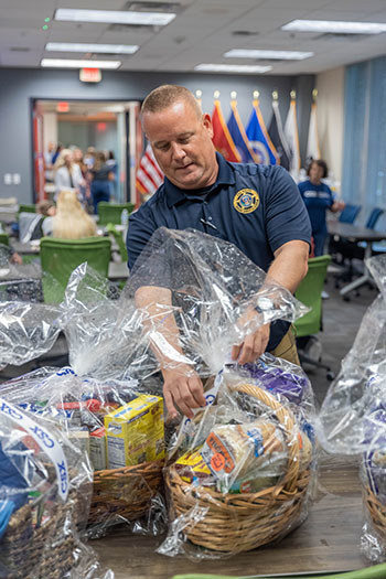 A volunteer helps drop off and organize food baskets for wounded warriors during an event at WWP's headquarters in Jacksonville, Florida. (Photo courtesy of CSX Pride in Service).