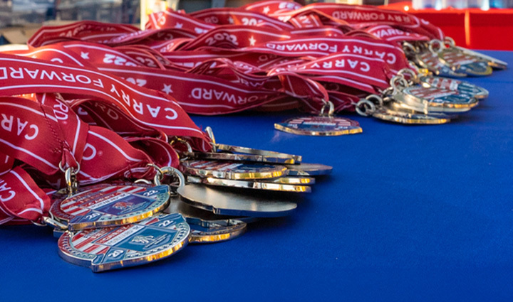 WWP Carry Forward 5K medals displayed on a table.