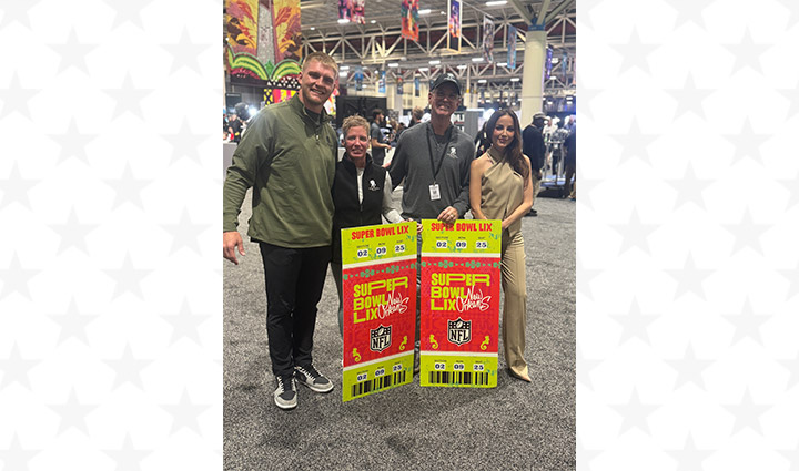 NFL player Trey McBride stands with warriors Natalie and Brian Vines who are holding enlargements of Super Bowl tickets and host Kay Adams at the Super Bowl Experience.