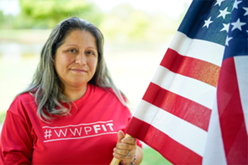 Woman holding an American flag outdoors