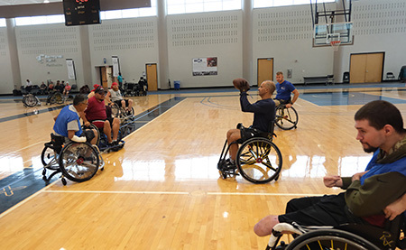Wounded warriors play basketball in a WWP Adaptive Sports clinic.