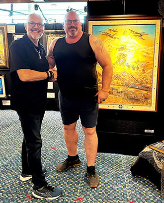 Marc poses with warrior Bill Hansen, who said he was particularly moved by the artwork Marc did to benefit WWP.