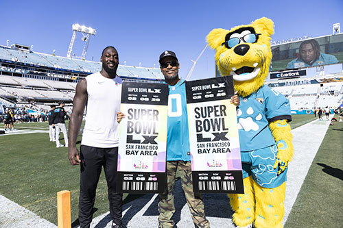 Jacksonville linebacker Devin Lloyd and Jaguars mascot Jaxson de Ville present Super Bowl tickets to WWP warrior