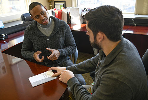 W WWP staff member goes over a pamphlet with a veteran about VA benefits.