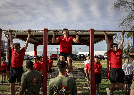 Marines do pullups during the Marine Corps' Initial Strength Test.