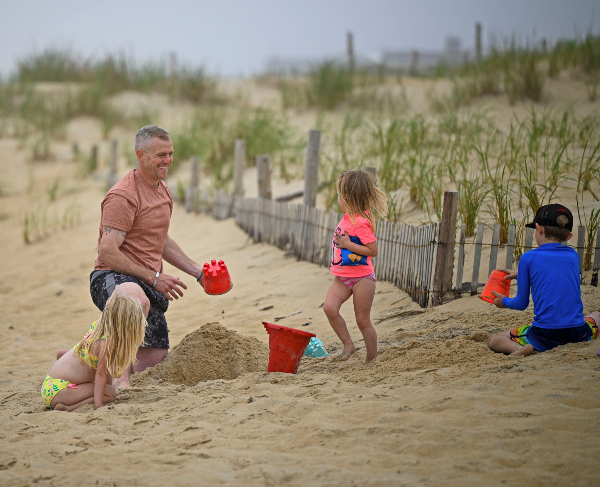 John Rego enjoys a beach day with his children.