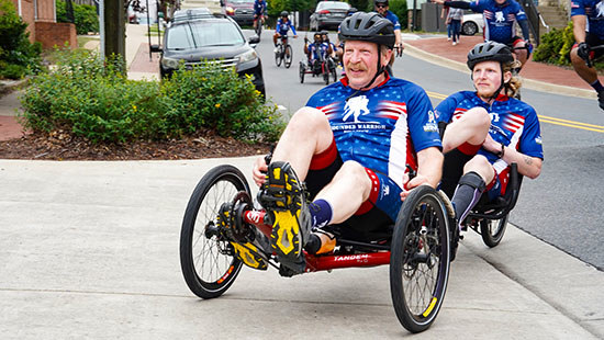 Father and son warriors ride a tandem recumbent bike during Soldier Ride 250.