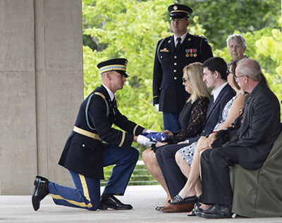 Tonya Star receives a flag during Major Star’s internment ceremony.