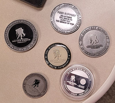 An assortment of Wounded Warrior Project challenge coins